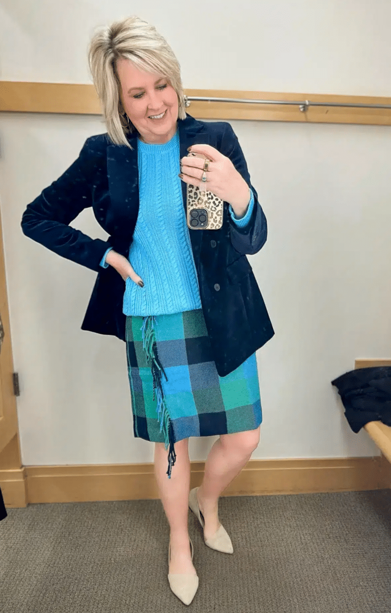 Tania Stephens is wearing a navy blazer and a plaid skirt